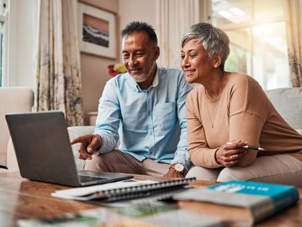 A couple viewing their computer screen.